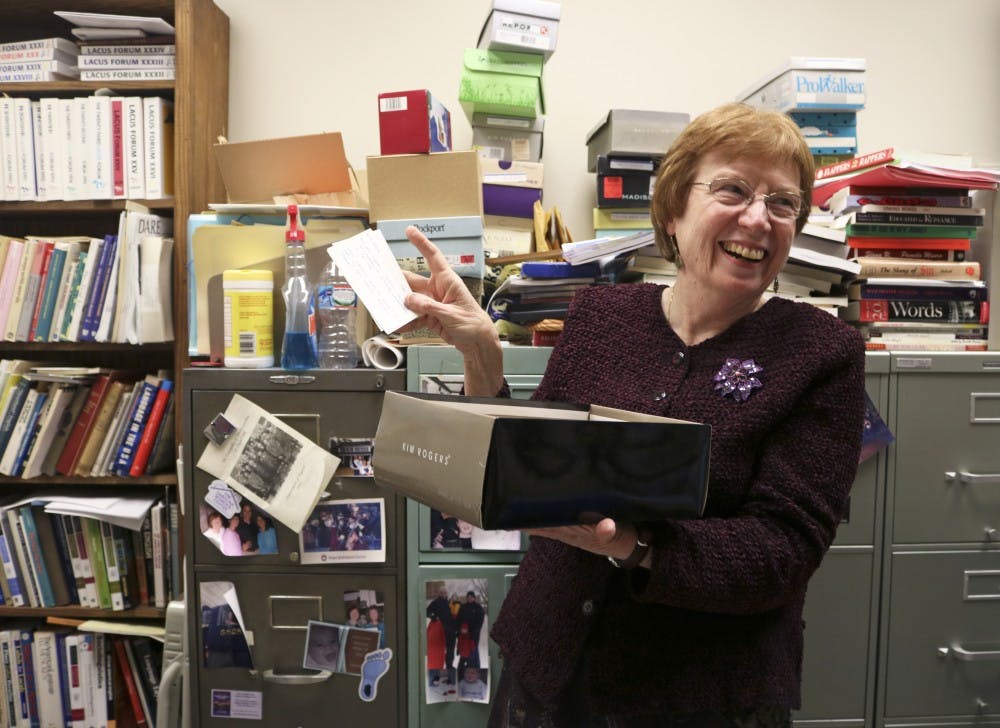 UNC prof. of English Connie Eble studies linguistics and slang, and is credited with having the earliest documentation of the phrase "shit happens". The phrase was submitted on one of the many notecards which the professor asks her students to submit definitions of current popular slang. Here prof. Eble is posing with the earliest notecard describing "shit happens".