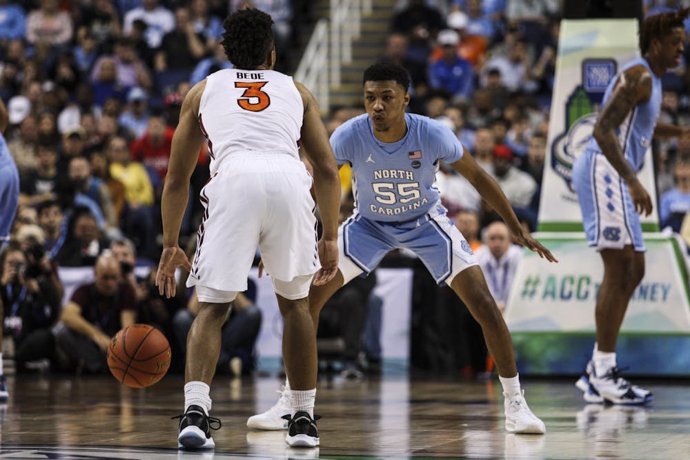 Graduate guard Christian Keeling (55) plays against Virginia Tech's Wabissa Bede (3) during the first round of the ACC tournament in the Greensboro Coliseum Complex on Tuesday, March 10, 2020.