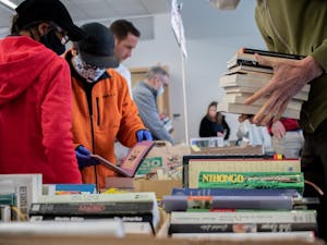 Shoppers look through boxes of books in Chapel Hill Public Library on Sunday, March 27, 2022. The book sale at Chapel Hill Public Library lasted from Friday, March 25 to Sunday, March 27.