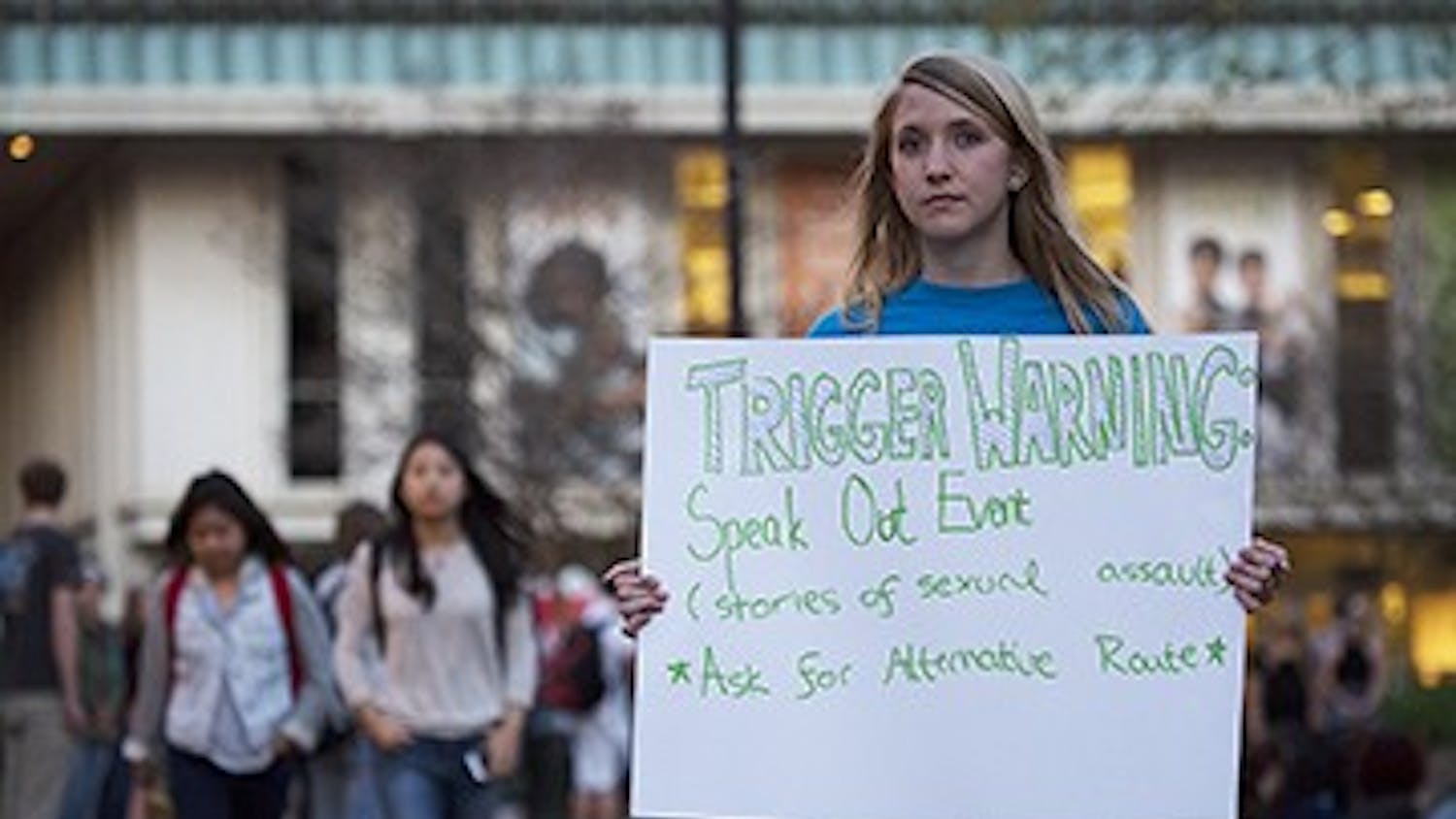 Alban Foulser directs students to Speak Out!, an event held in The Pit Tuesday evening by the Project Dinah organization. Members of the group read anonymous testimonials from survivors of sexual assault to students and onlookers.