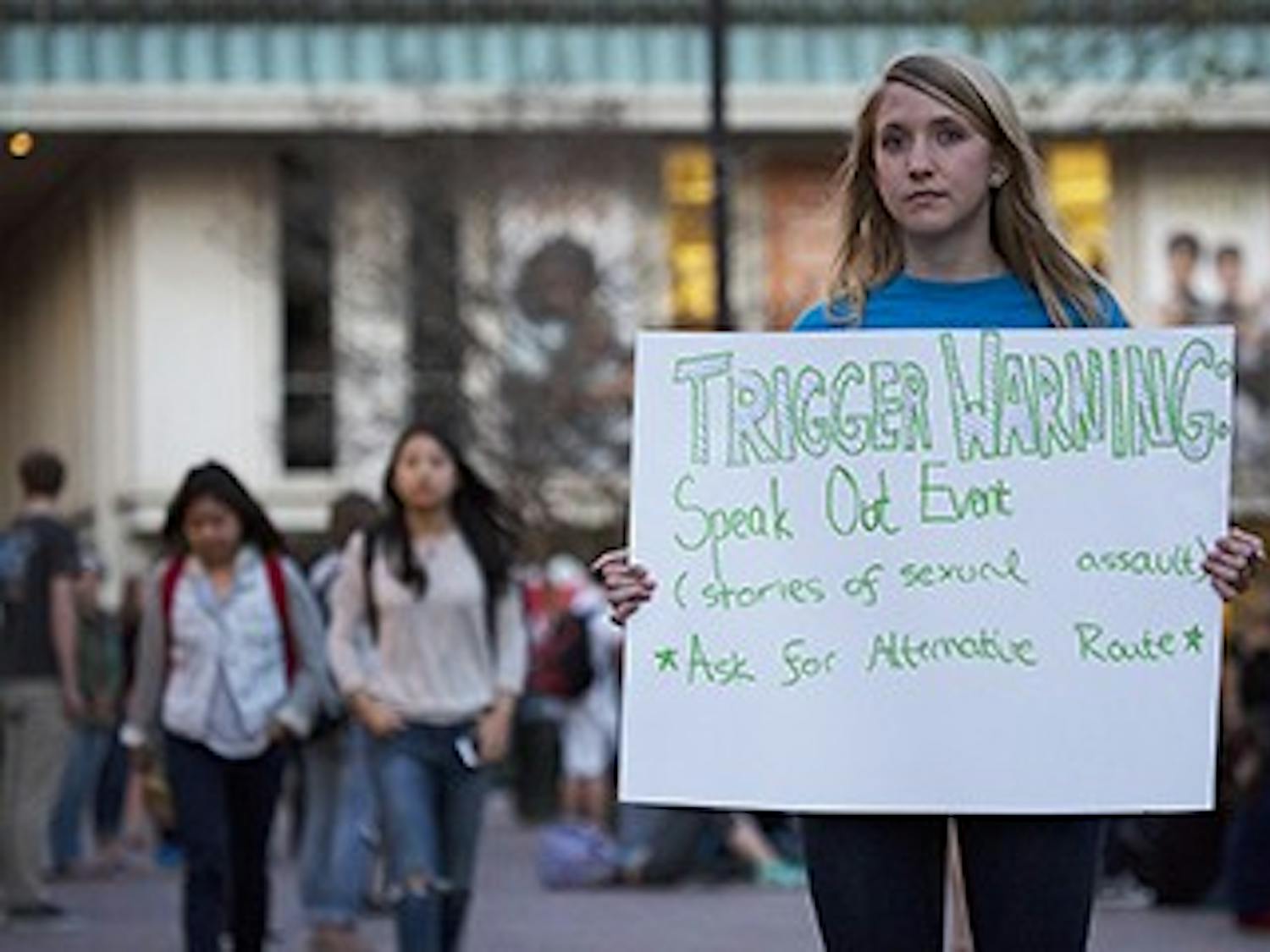 Alban Foulser directs students to Speak Out!, an event held in The Pit Tuesday evening by the Project Dinah organization. Members of the group read anonymous testimonials from survivors of sexual assault to students and onlookers.