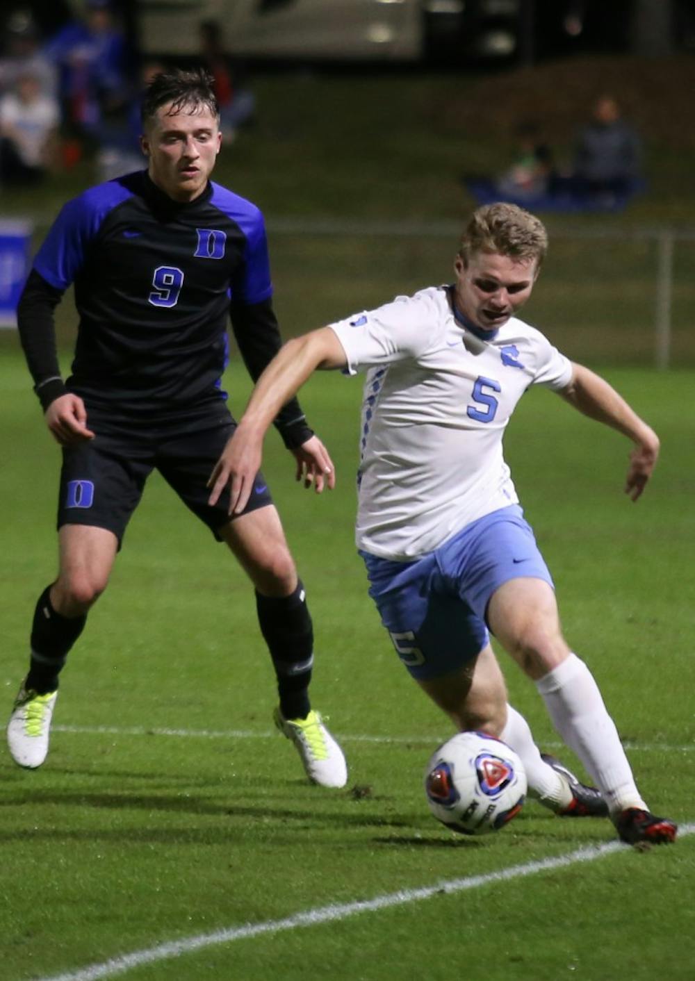 <p>Sophomore midfielder John Nelson (5) dribbles down the line during the semifinals of the ACC Championship. UNC men's soccer beat Duke 2-1.</p>