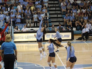 Raleigh Clark, redshirt first-year and middle hitter for the Tar Heels' women's volleyball team, hits the ball back to other side of the court in a game against N.C. State on Wednesday, Sept. 26, 2018.