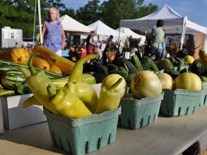 Customers choose from bountiful summer produce from Cate's Corner Farm. All vendors are spaced out 10-20 feet apart, depending where they are in the Market. Photo courtesy of Maggie Funkhouser.