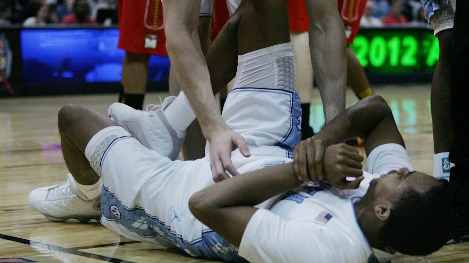 Junior John Henson grabs his wrist after getting injured early in the game. Henson spent most of the night on the bench tending to his wrist, seeing only 7 minutes of play time and scoring only 3 points for the night. 