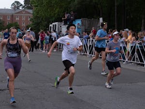 Racers sprint the final stretch past Teague Residence Hall during the Tar Heel Ten Miler on Saturday, April 22, 2023.