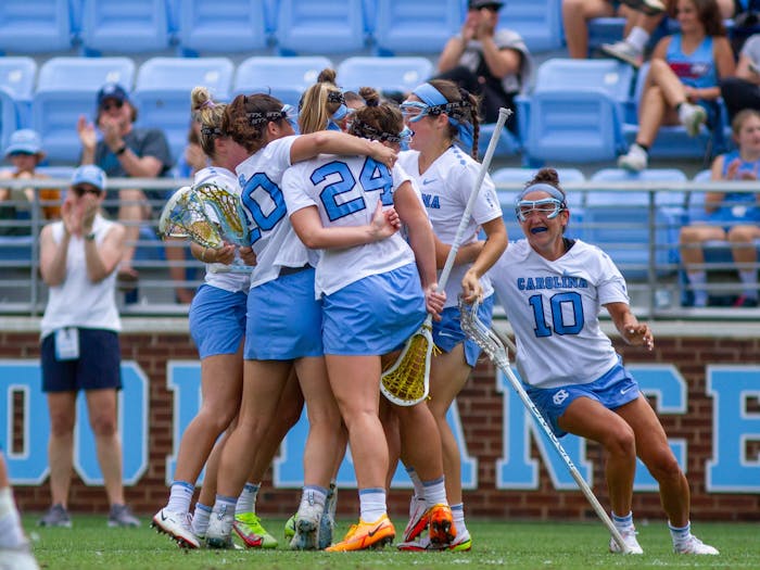 Members of the UNC women's lacrosse team celebrate a goal during their NCAA Tournament second round match against Virginia at Dorrance Field on Sunday, May 15, 2022. UNC won 24-2.