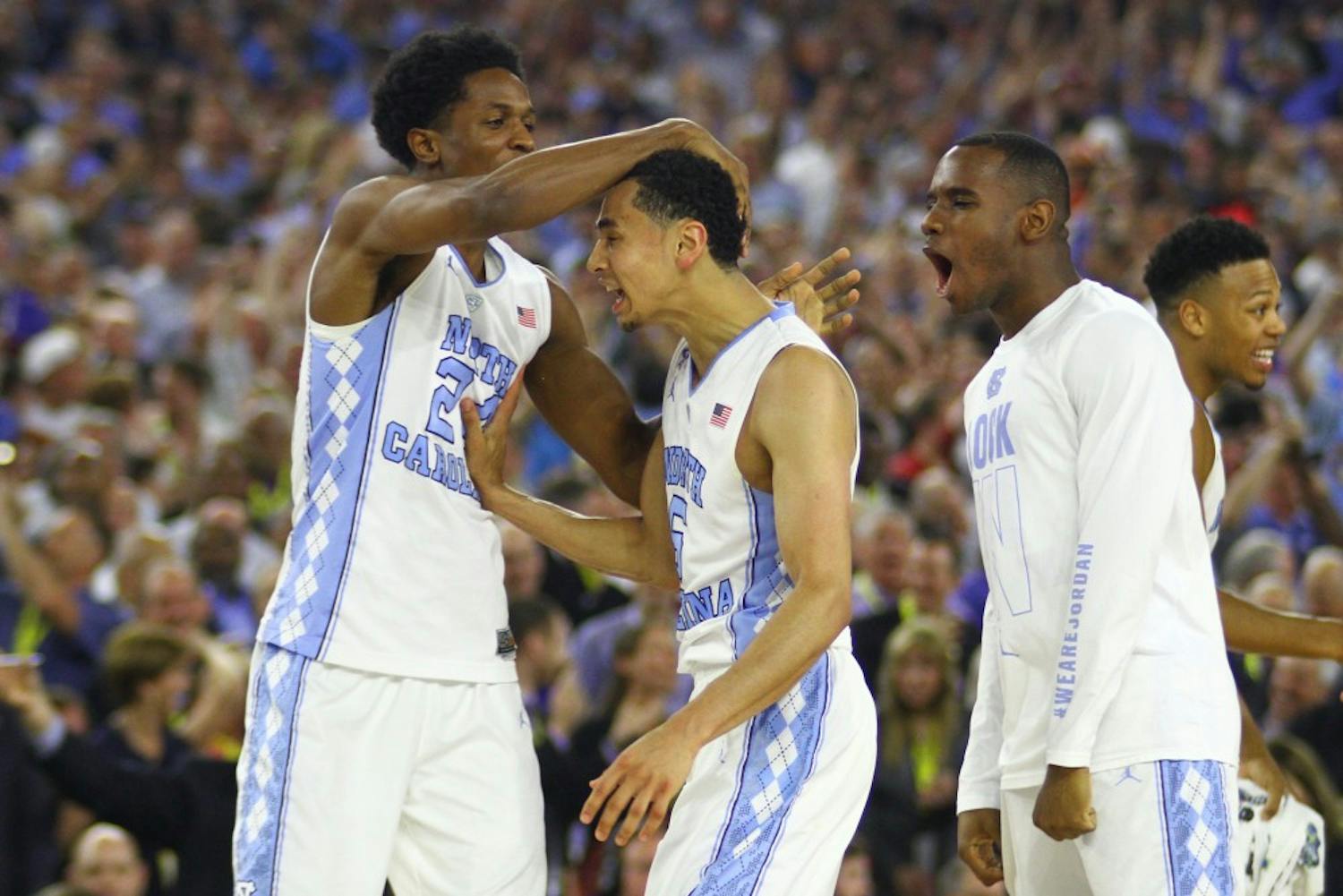 Kenny Williams (left) congratulates Marcus Paige after making a three-point shot in the last five seconds of the game.
