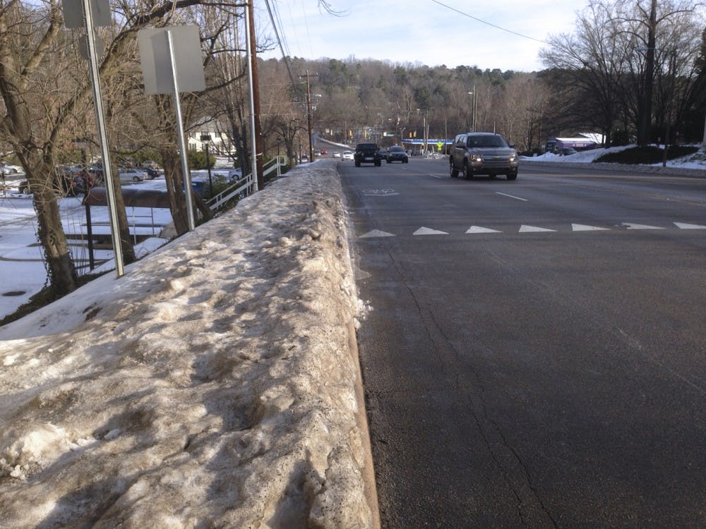 <p>A view towards Hillsborough Drive on Martin Luther King Jr. Blvd. On Tuesday morning, the road was clear, and the sidewalks remained obstructed.</p>