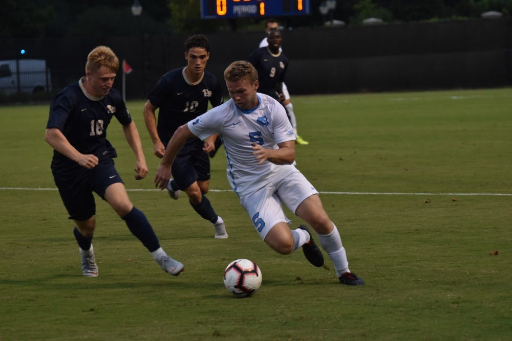 Center defender John Nelson (5) fights for the ball against midfielder Tim Townsend (18) during Saturday night's game against Pittsburgh at Koskinen Stadium.