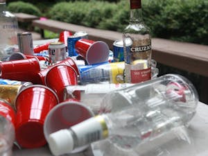Alcohol bottles and cans litter a table after a birthday party in Chapel Hill in August 2018. 