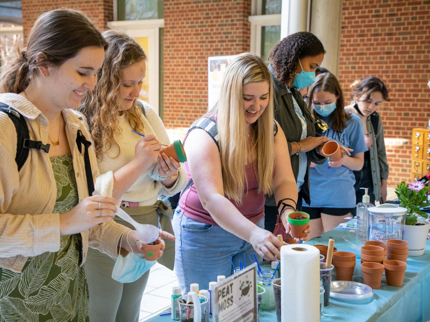 Students decorate pots and plant seeds at the Kenan Science Library's seed library launch party on Wednesday, Mar. 2, 2022.