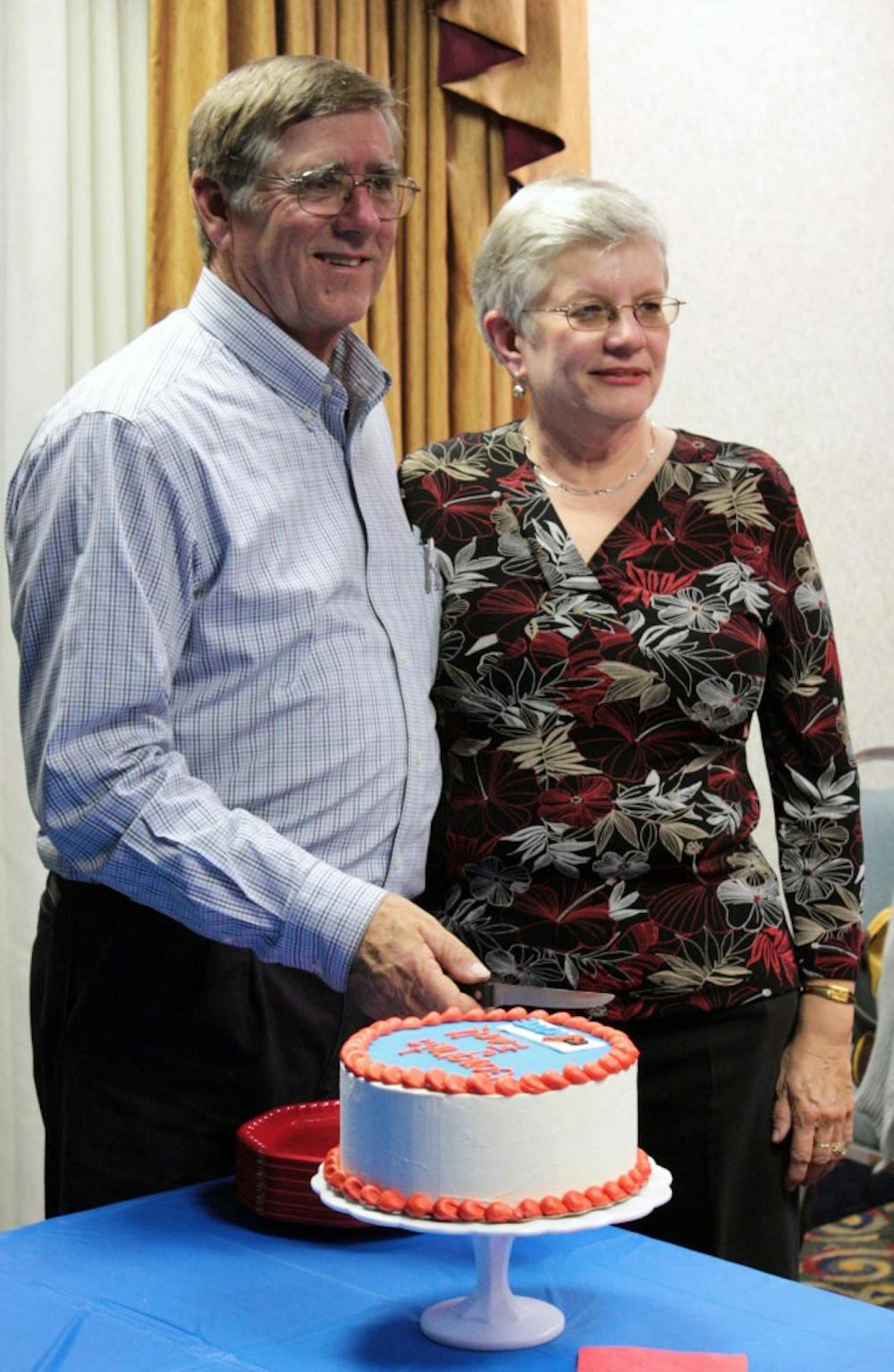 Earl McKee, Democratic candidate for the Orange County Board of COmmissioners, stands with his wife, Sandra, Tuesday evening before cutting into a cake to celebrate his victory. 