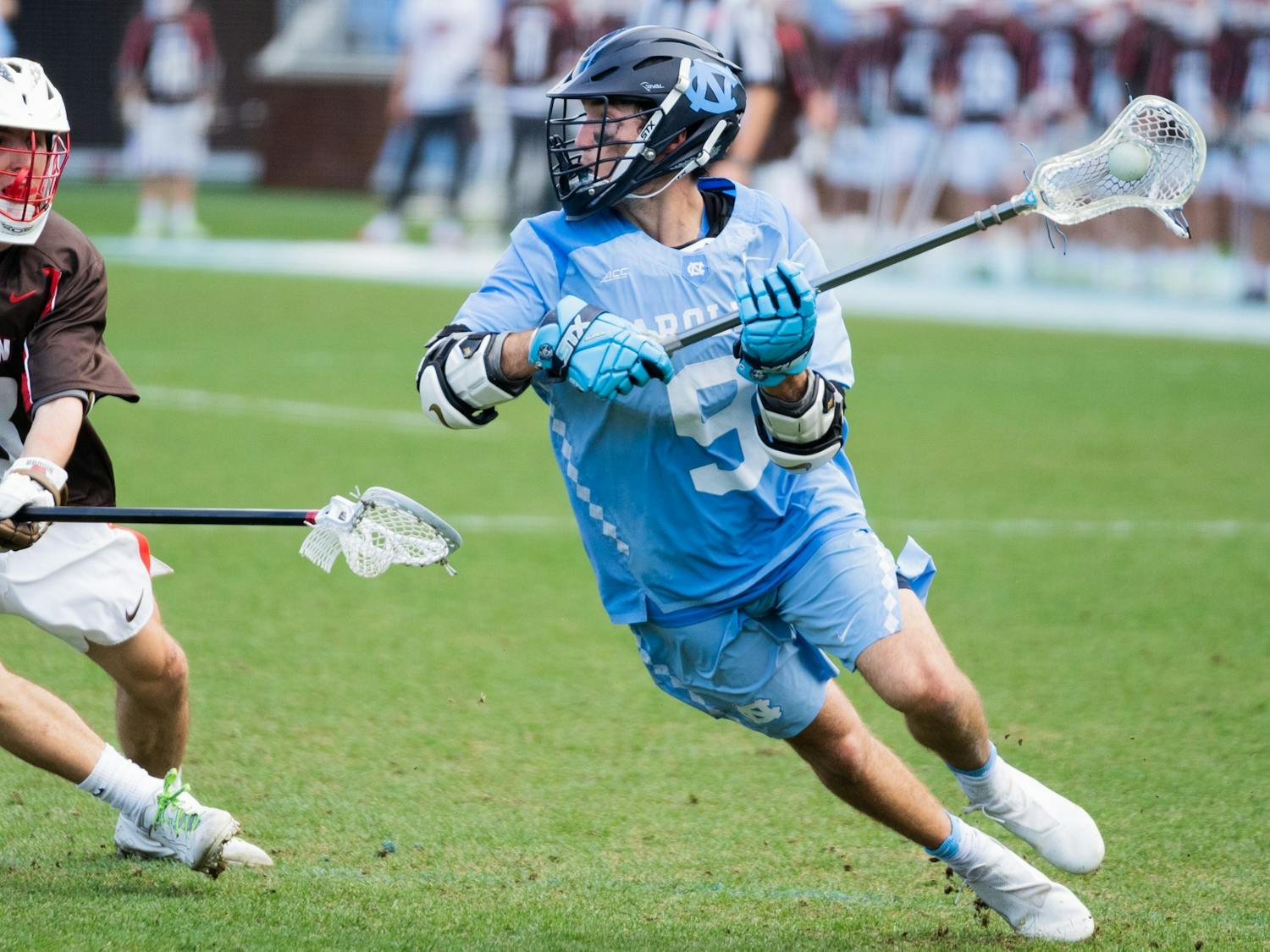 UNC senior attackman Jacob Kelly (9) looks to cross the ball during a men's lacrosse game at Dorrance Stadium on Wednesday, Feb. 23, 2022. UNC won 14-11.