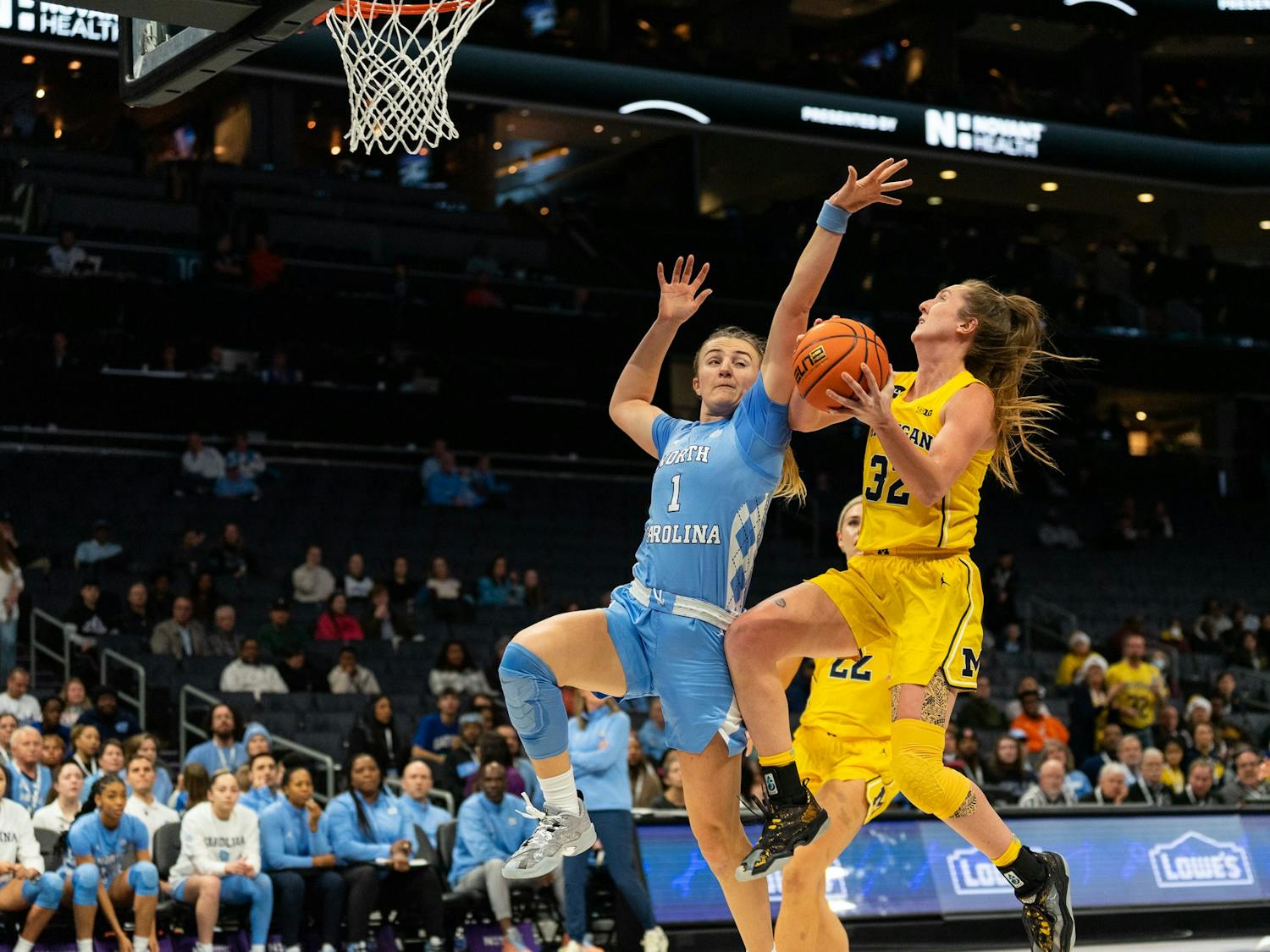 UNC junior guard Alyssa Ustby (1) attempts to block Michigan fifth-year guard Leigha Brown (32) during the women’s basketball game against Michigan at the Jumpman Invitational on Tuesday, Dec. 20, 2022, at the Spectrum Center. UNC fell to Michigan 76-68.