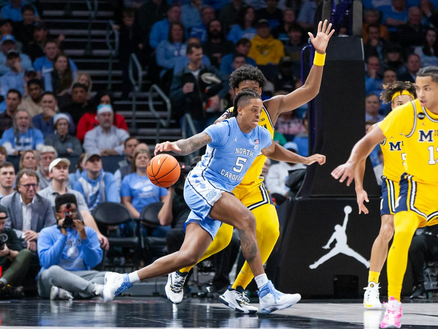 UNC senior forward/center Armando Bacot (5) dribbles the ball during the men's basketball game against Michigan at the Jumpman Invitational in Charlotte, N.C., on Wednesday, Dec. 21, 2022. UNC beat Michigan 80-76.