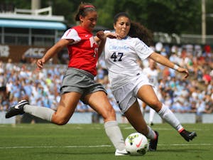 UNC midfielder Alex Kimball (47) and Ohio State defender Bridget Skinner try to make a play on the ball late in the game.  The Tar Heels would go on to defeat the Buckeyes 1-0.