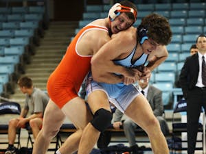 	Zac Bennett tries to escape a waistlock against Virginia earlier this season. Bennett sees Saturday’s opponent Nebraska as a team UNC should aspire to. The Cornhuskers come to Chapel Hill ranked No. 13 in the country.