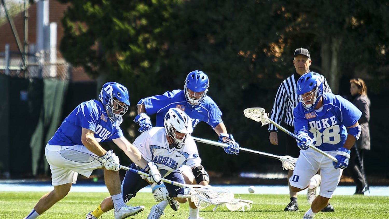UNC senior attackman Joey Sankey (11) fights for the ball.