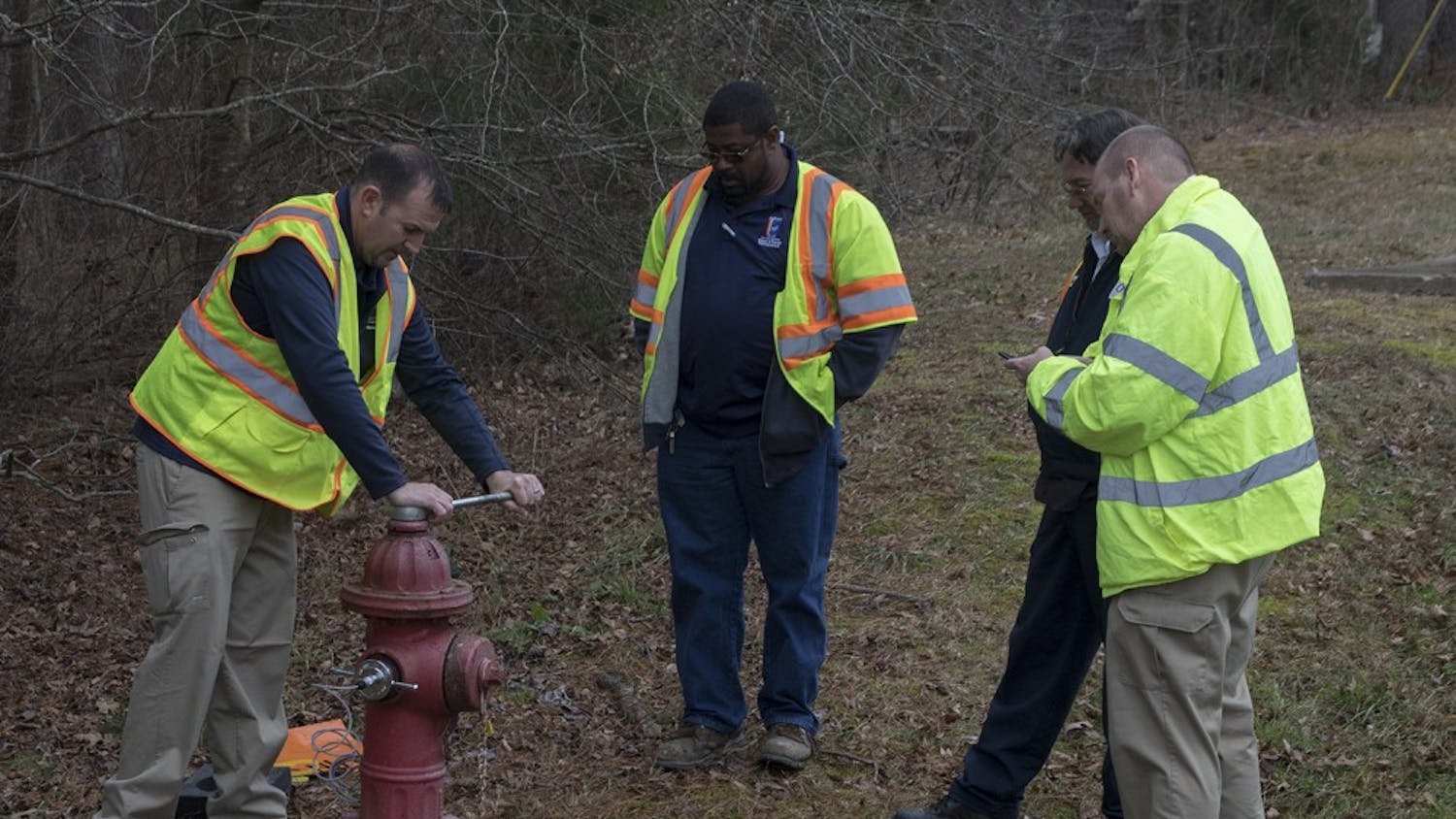 OWASA workers test a fire hydrant near the Friday Center during the water shortage.