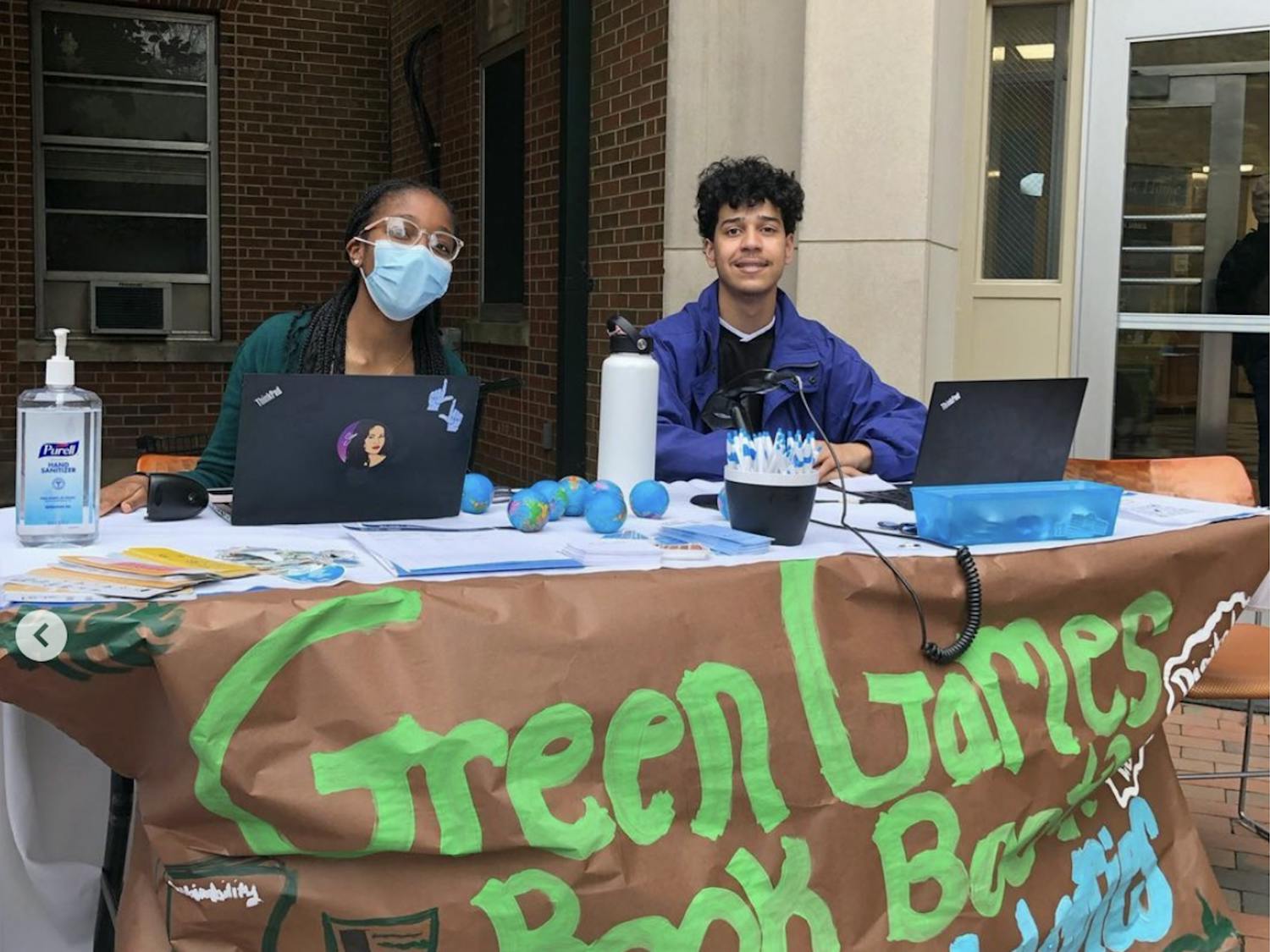 Library staff and RAs sit at a sustainability-themed book booth in front of Hinton James Residence Hall on Thursday, March 24, 2022. Photo courtesy of UNC Library Communications.