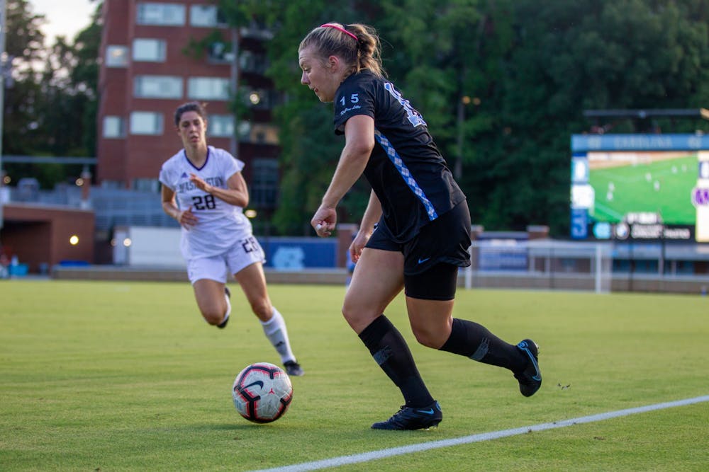 UNC sophomore forward/midfielder Avery Patterson (15) dribbles the ball at the soccer game against Washington on Thursday August 19, 2021 at the Dorrance Field.