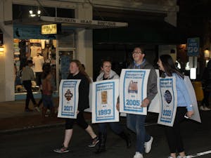 (left to right) Alexis Byrd, Annabeth Poe, Tyler Brown, and Jessica Hardison strolled down Franklin St. as UNC's National Championship banners. 