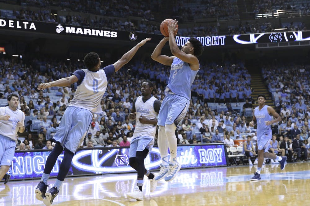 UNC guard Joel Berry (2) pulls up for a 3-point shot over guard Nate Britt (0) during the Late Night with Roy scrimmage.