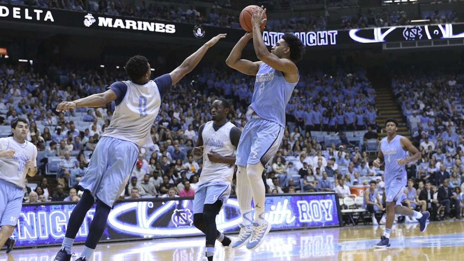 UNC guard Joel Berry (2) pulls up for a 3-point shot over guard Nate Britt (0) during the Late Night with Roy scrimmage.