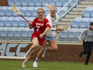 UNC women's junior midfielder Scottie Rose Growney (15), chases her Davidson opponent at Dorrance Field on Sunday, Feb. 16, 2020. UNC were leading 15-1 by halftime and defeated Davidson with a final score of 22-5.
