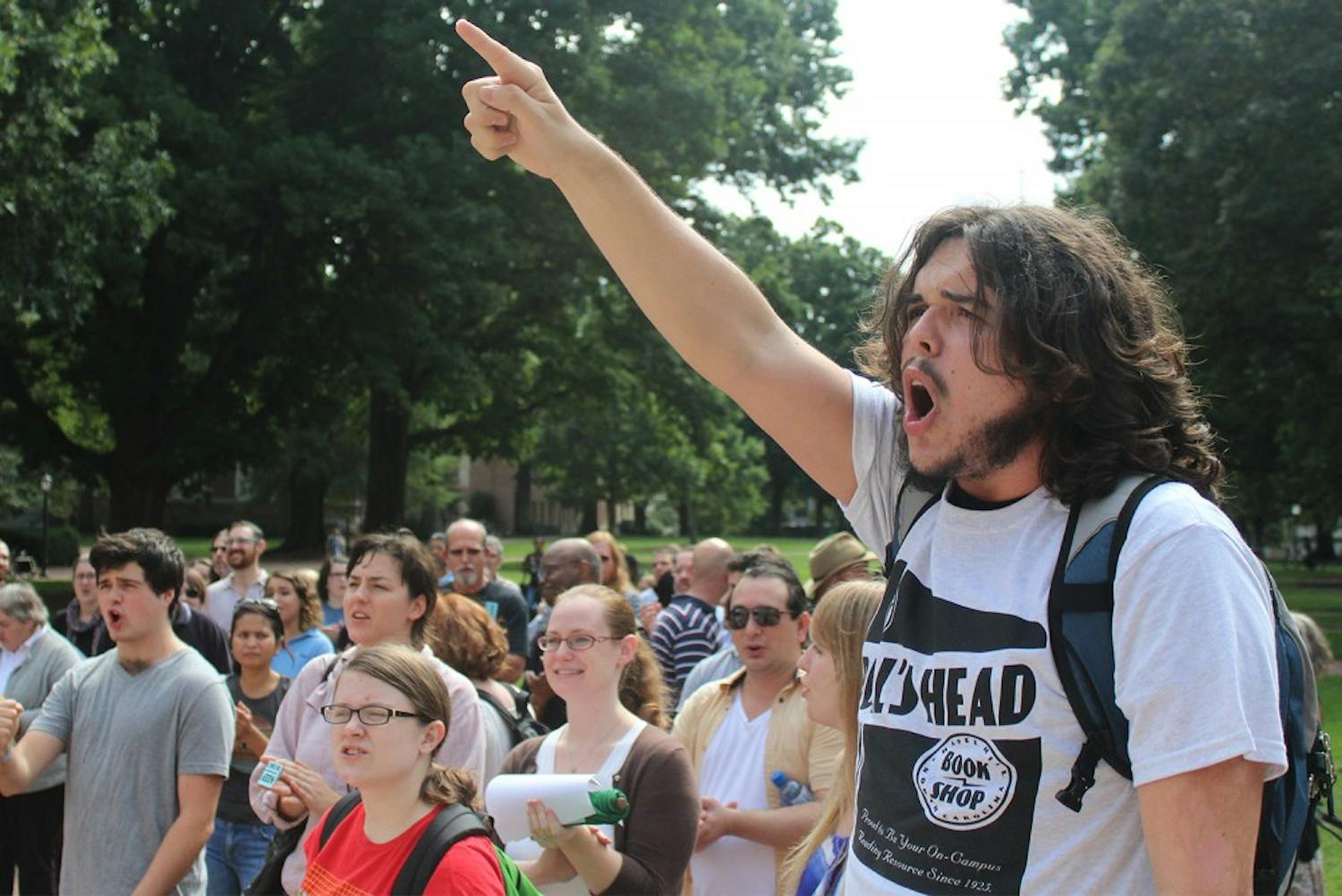 Students and staff protest the possible privatization of the UNC Student Stores: Freshman Tristan Bavol (linguistics major) (right) helps lead demonstrators in front of the South Building 