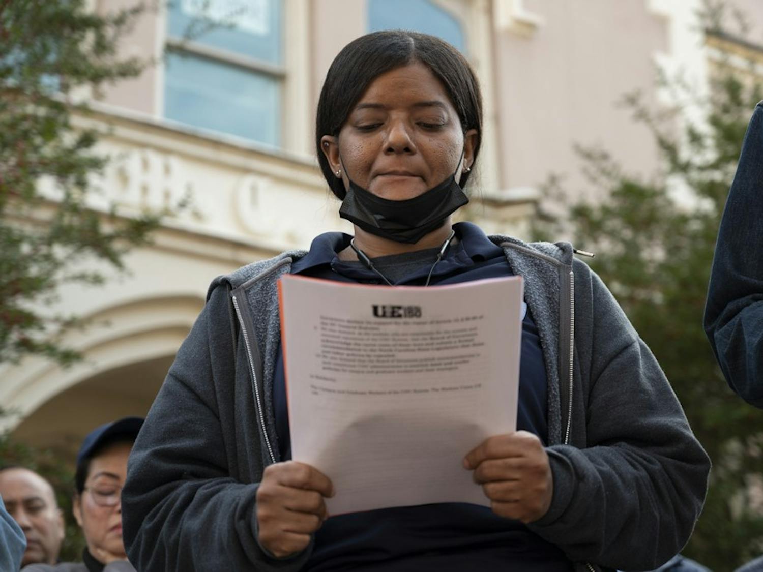 Vinyasa Burnette reads out the demands for UNC Housekeepers to receive better pay outside of the Campus Y on Wednesday, Jan. 18, 2023.