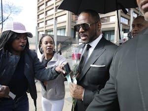 Fans give singer R. Kelly a rose, and cards, outside the Leighton Courthouse on March 22, 2019, in Chicago, Illinois. 
Photo Courtesy of Nuccio DiNuzzo/Getty Images/TNS