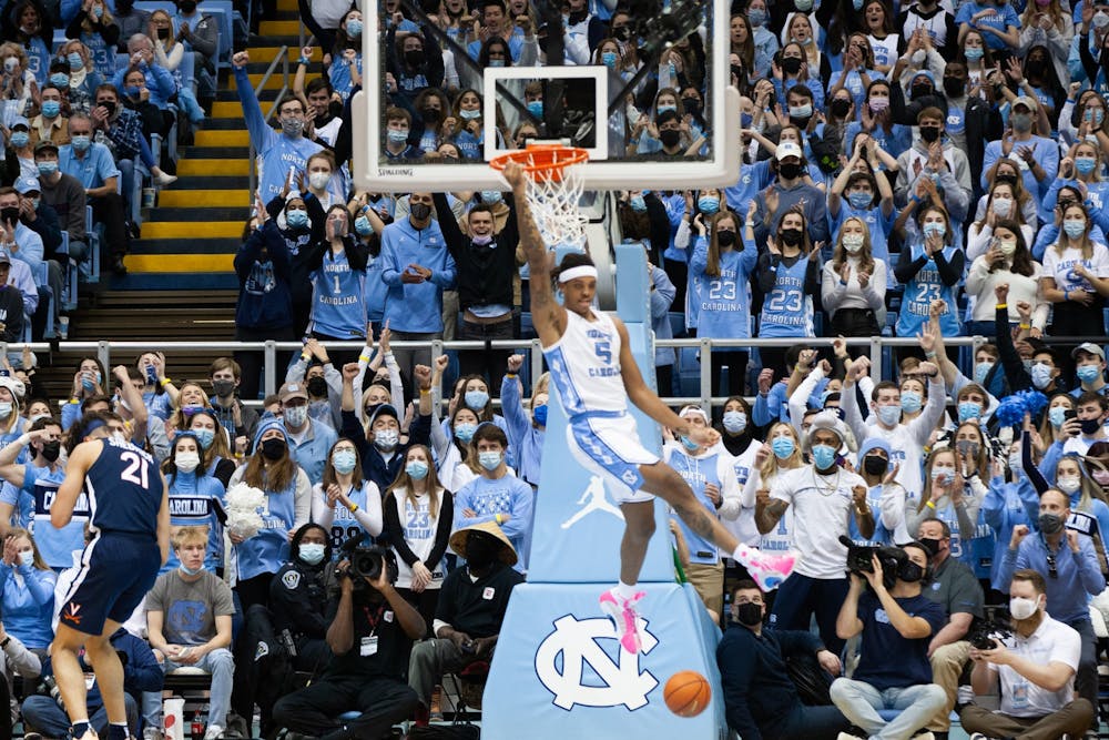 UNC students cheer as junior forward Armando Bacot (5) dunks the ball at the game against Virginia at the Smith Center in Chapel Hill on Jan. 8, 2022. UNC won 74-58.