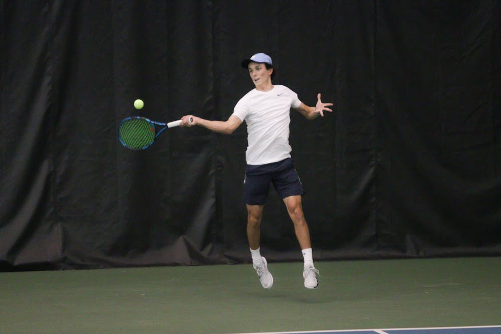 <p>Sophomore Peter Murphy jumps to return the ball in his singles match. UNC Men's Tennis beat NCCU 5-0 at Cone-Kenfield Center on Wednesday, Feb. 9, 2022.</p>