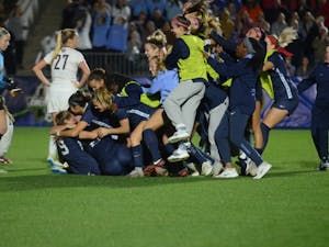 The UNC women's soccer team celebrates with a dog pile after defeating Georgetown in the 108th minute, 1-0, in the College Cup semifinals on Nov. 30, 2018 at Sahlen's Stadium at WakeMed Soccer Park in Cary.