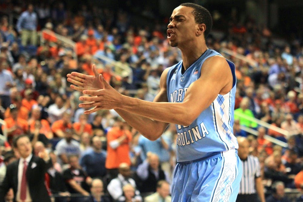 <p>Brice Johnson celebrates a dunk during the first half. Johnson led the Tar Heels in points and rebounds in Thursday's game against Louisville. </p>