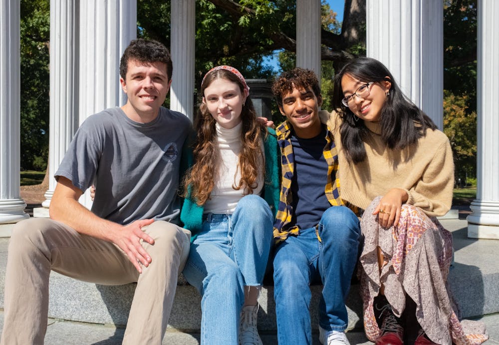 Junior Marshall Graham, sophomore Anna Souhan, junior Jean Camejo, and sophomore Sarah Zhang of PPGA posing for a portrait at the Old Well on Oct. 10, 2022.