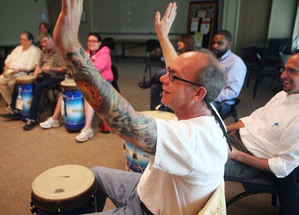 Newman Montgomery takes part in a drum circle Wednesday at the UNC Wellness Center. DTH/ Margaret Cheatham Williams