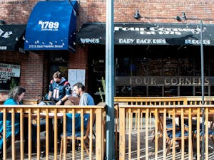A family dines outdoors at Four Corners on Nov. 29, 2021. The restaurant and sports bar has faced staffing issues over the past year, along with other establishments on Franklin Street.