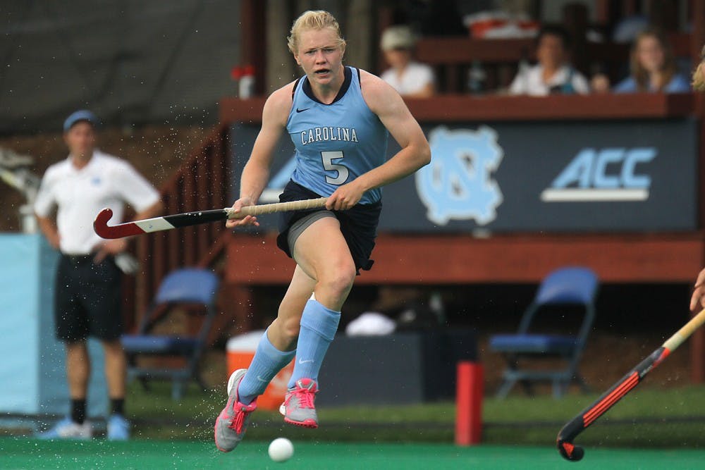 UNC forward Charlotte Craddock runs up the field during a break against a Syracuse University defender on Friday's matchup.