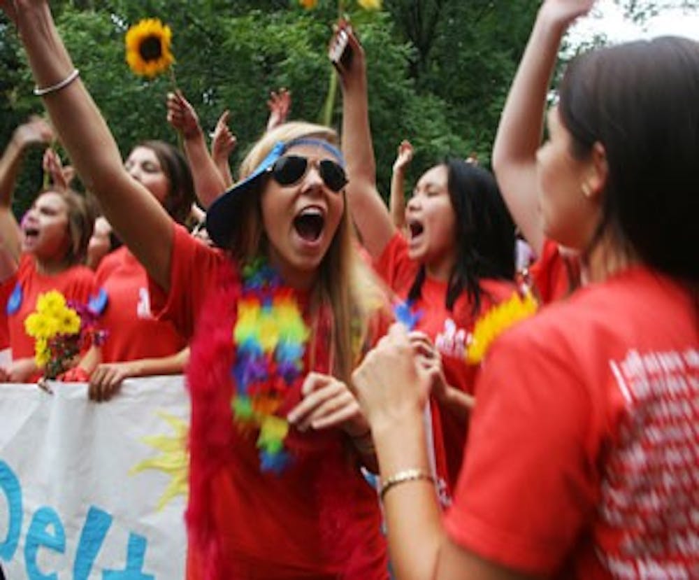 Anna Dixson and her sorority sisters from Alpha Delta Pi cheer as bid candidates enter the Coker Arboretum on Thursday.