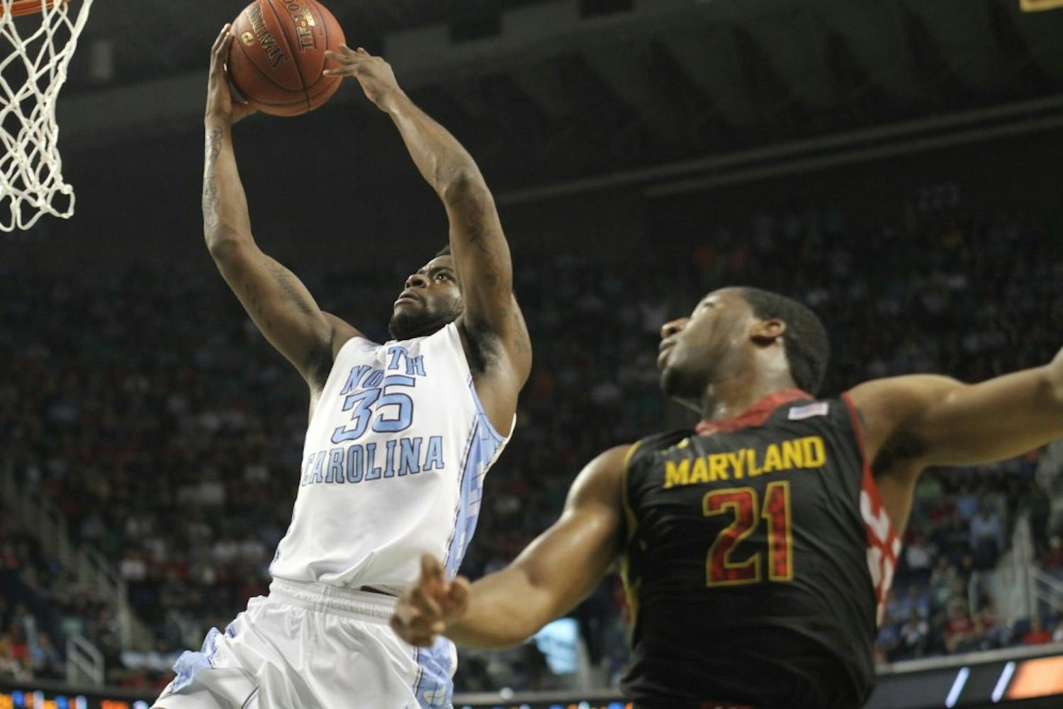 	Reggie Bullock goes for an open layup while Maryland&#8217;s Pe&#8217;Shon Howard watches.