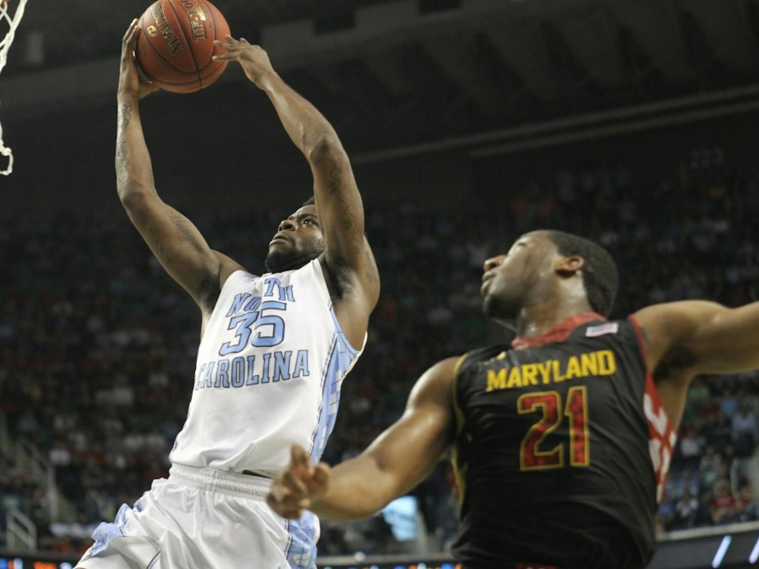 	Reggie Bullock goes for an open layup while Maryland&#8217;s Pe&#8217;Shon Howard watches.
