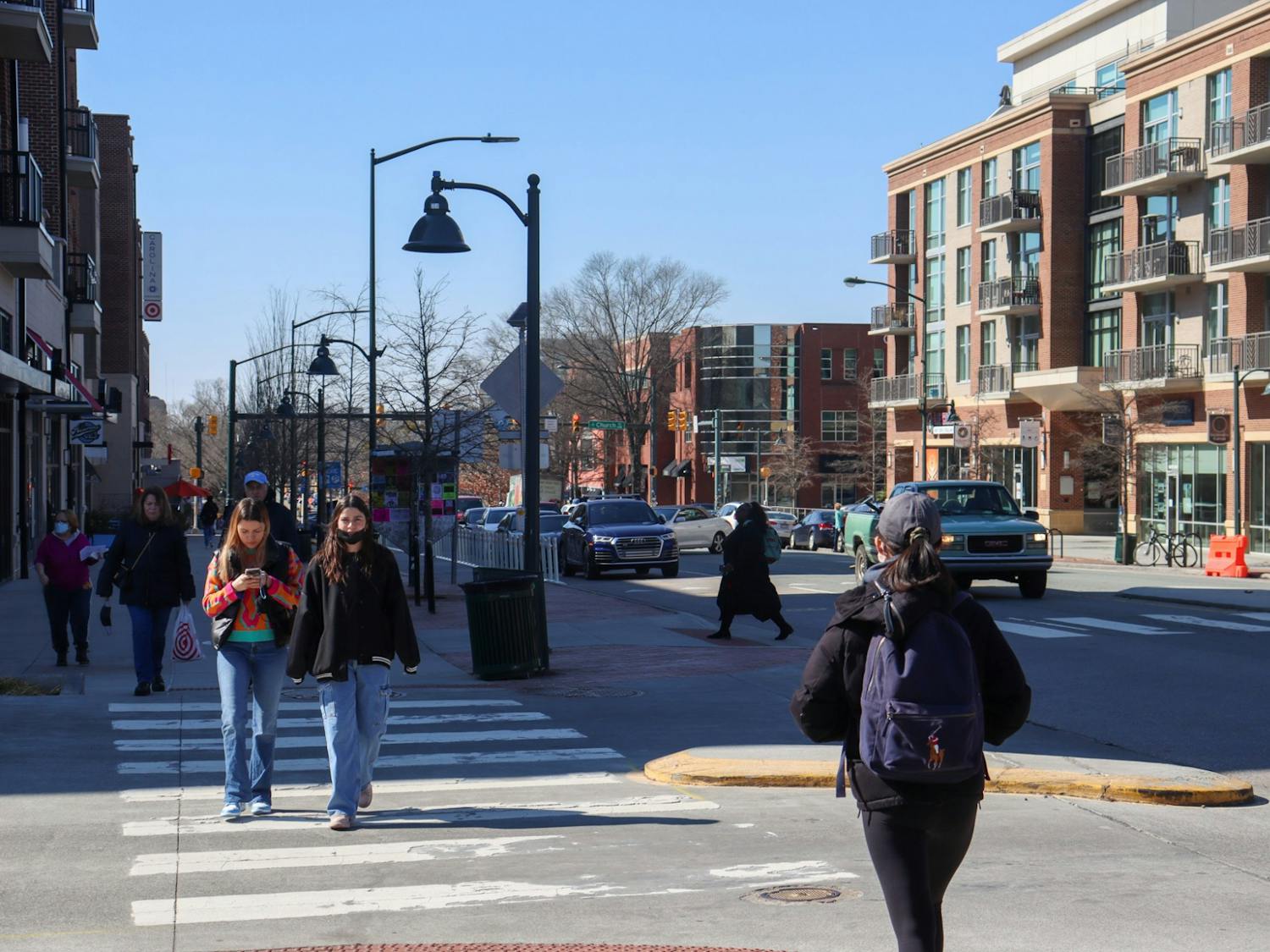 Pedestrians cross the crosswalk on W Franklin Street on Monday, Feb. 14, 2022.
