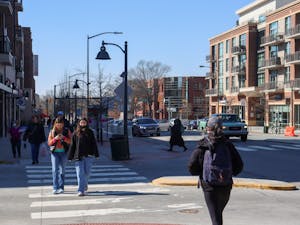 Pedestrians cross the crosswalk on W Franklin Street on Monday, Feb. 14, 2022.