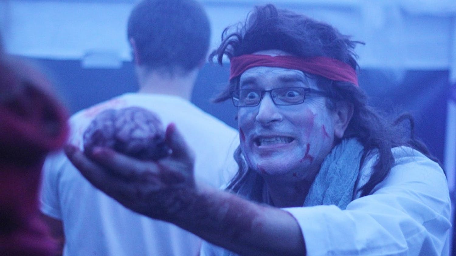 	Tom Davis scares people with a pretend brain as they walk through a haunted hospital at the Hillsborough Spooktacular on Saturday evening. The annual event, hosted by the Orange County Department of Environment, Agriculture, Parks &amp; Recreation, featured activities for children and families. 