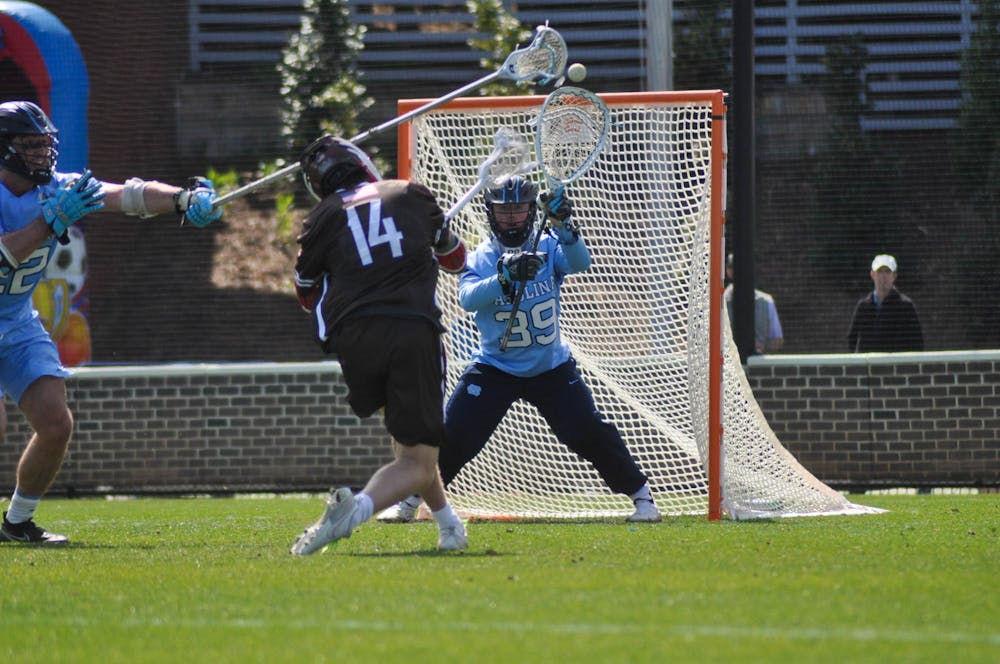 <p>UNC junior goalkeeper Collin Krieg (39) blocks a shot during the men's lacrosse game against Brown at Dorrance Field on Saturday, March 11, 2023. UNC won 19-6.</p>
