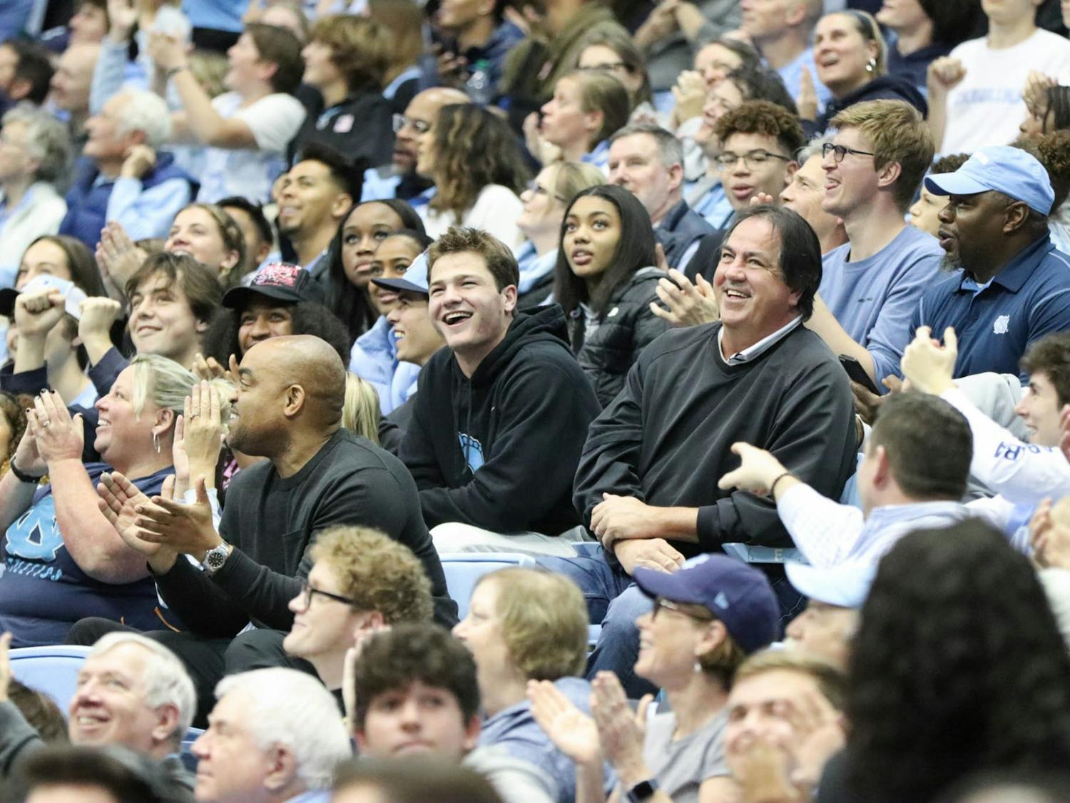 UNC first-year quarterback Drake Maye and his father, Mark Maye, smile in the crowd during the men's basketball game against Gardner-Webb at the Dean Smith Center on Tuesday, Nov. 15, 2022. UNC beat Gardner-Webb 72-66.