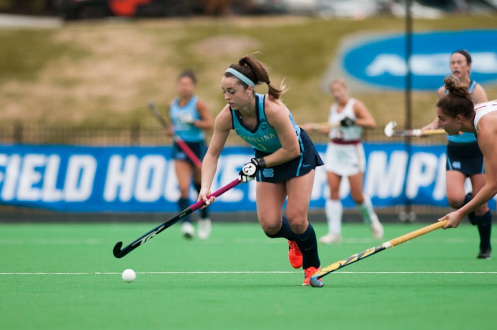 UNC Sophomore forward Erin Matson (1) dodges past Boston College player as she dribbles the ball towards the goal in the NCAA Final Four game against BC at Kentner Stadium on Friday, Nov. 22, 2019. UNC won 6-3, with four goals scored by Matson.